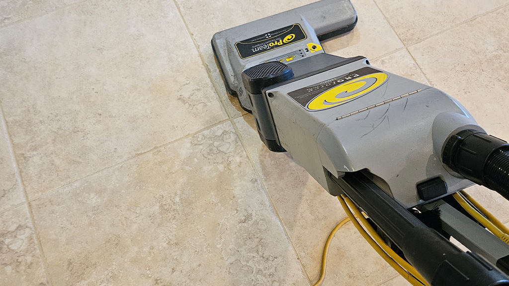 Vacuuming the floor to remove dry debris
